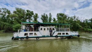 Safca Ionel - Danube Delta Cruises - driving the Pelicanul slowbat. Sejur Delta Dunarii
